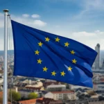 علم الاتحاد الأوروبي يرفرف فوق مدينة أوروبية، مما يعكس جمال وثقافة دول الاتحاد التي توفر فرص دراسة بتكاليف منخفضة للطلاب الدوليين. أرخص 10 دول للدراسة.