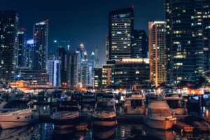 إطلالة ليلية على مرسى دبي مع الأضواء المتلألئة واليخوت الراسية أمام الأبراج الشاهقة.